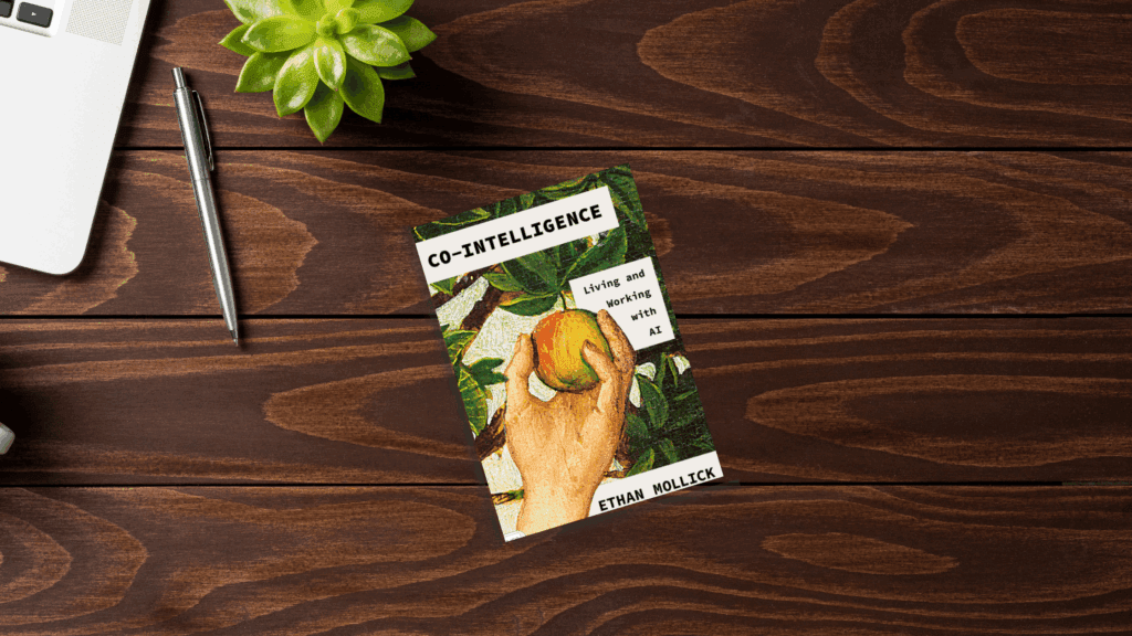 Desktop with a book cover for the book Co-Intelligence by Ethan Mollick.